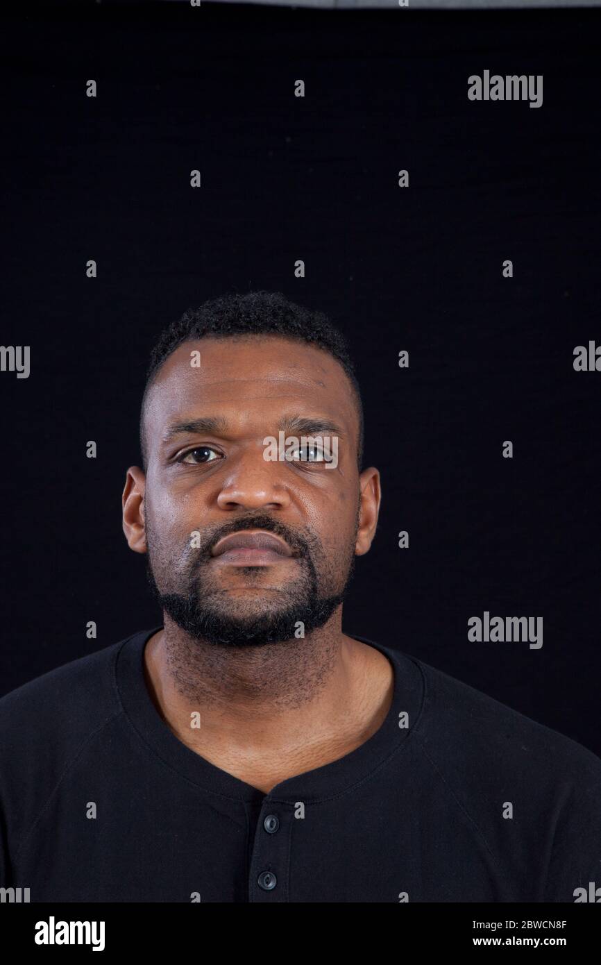 Pensive Black man in a black shrit Stock Photo - Alamy