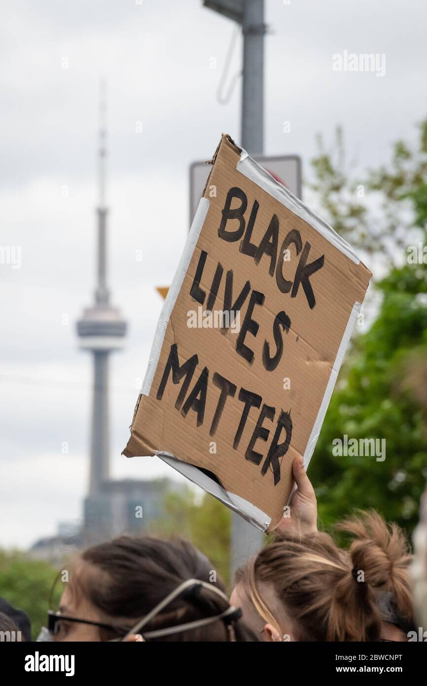 A protester holds a Black Lives Matter sign while marching through Toronto, Ontario, in response to Regis Korchinski-Paquet's death. Stock Photo