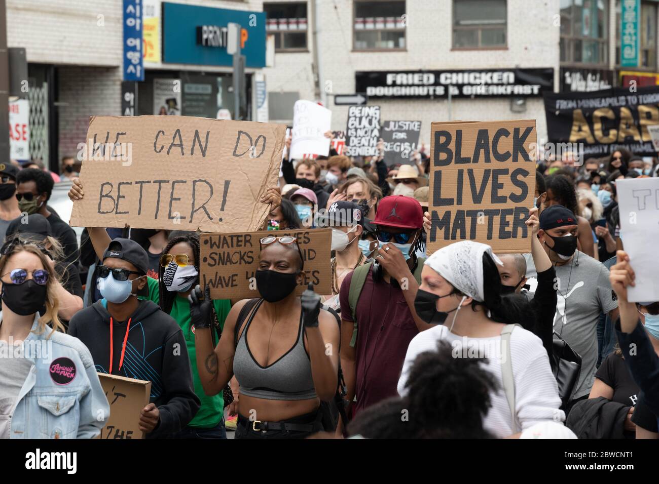 Protesters march through downtown Toronto to protest law enforcement in reaction to Regis Korchinski-Paquet's and George Floyd's deaths. Stock Photo