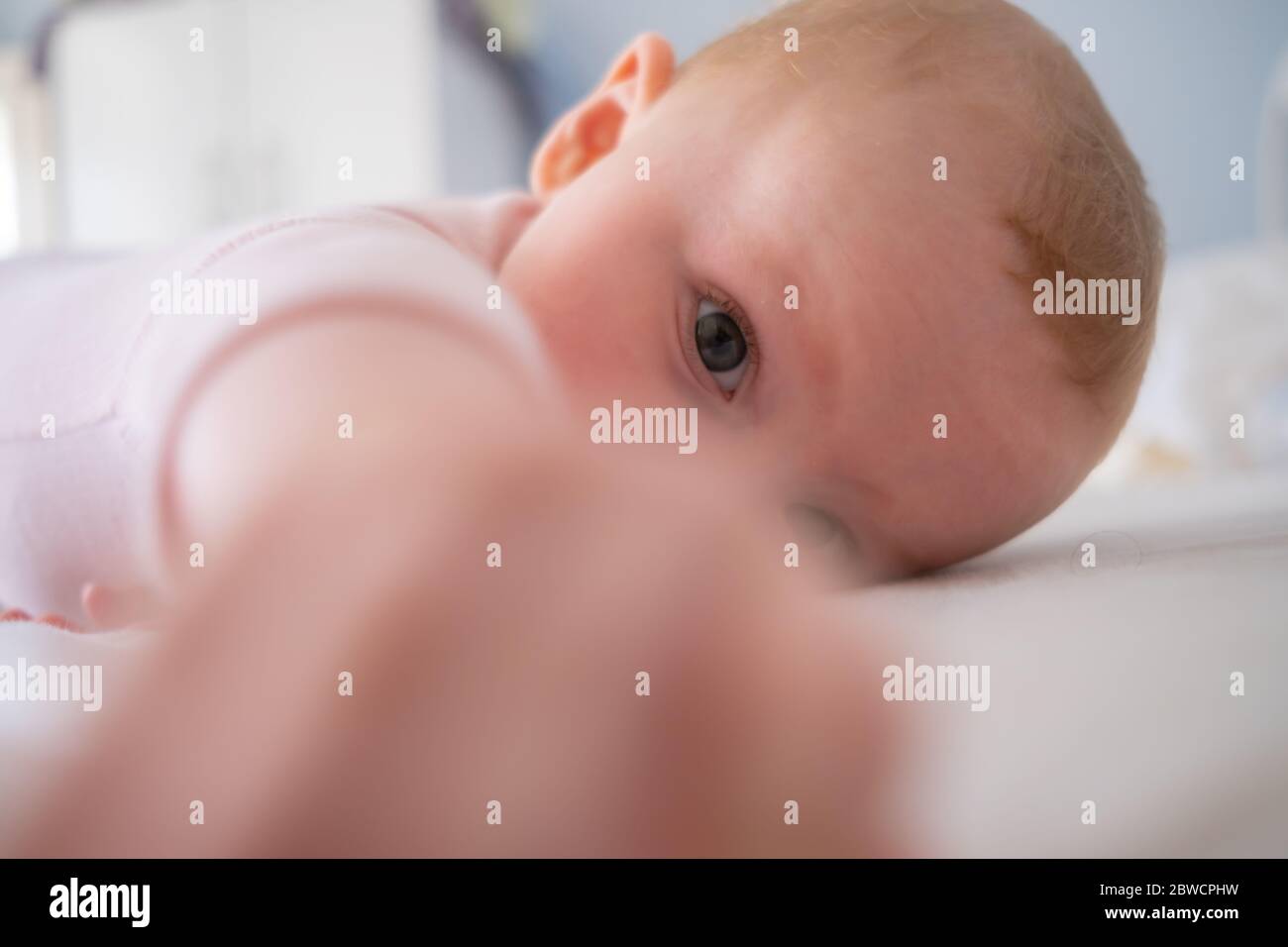 Cute baby girl standing on bed make funny faces, angry face, crying in the morning Stock Photo