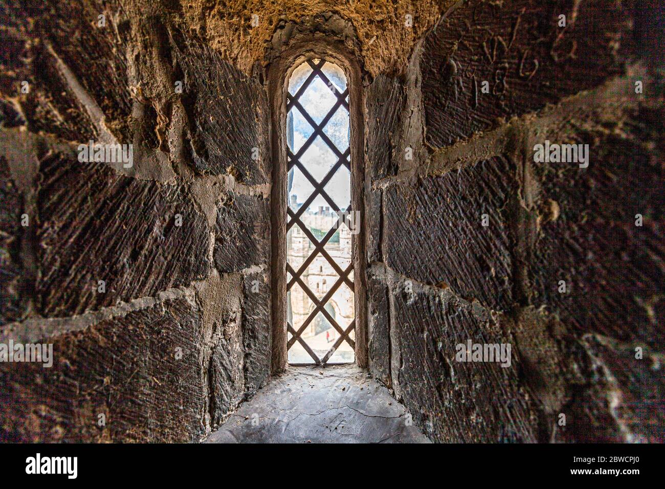 Looking through thick walls that once served as embrasures out of Small Window in the Tower of Lincoln Cathedral Stock Photo