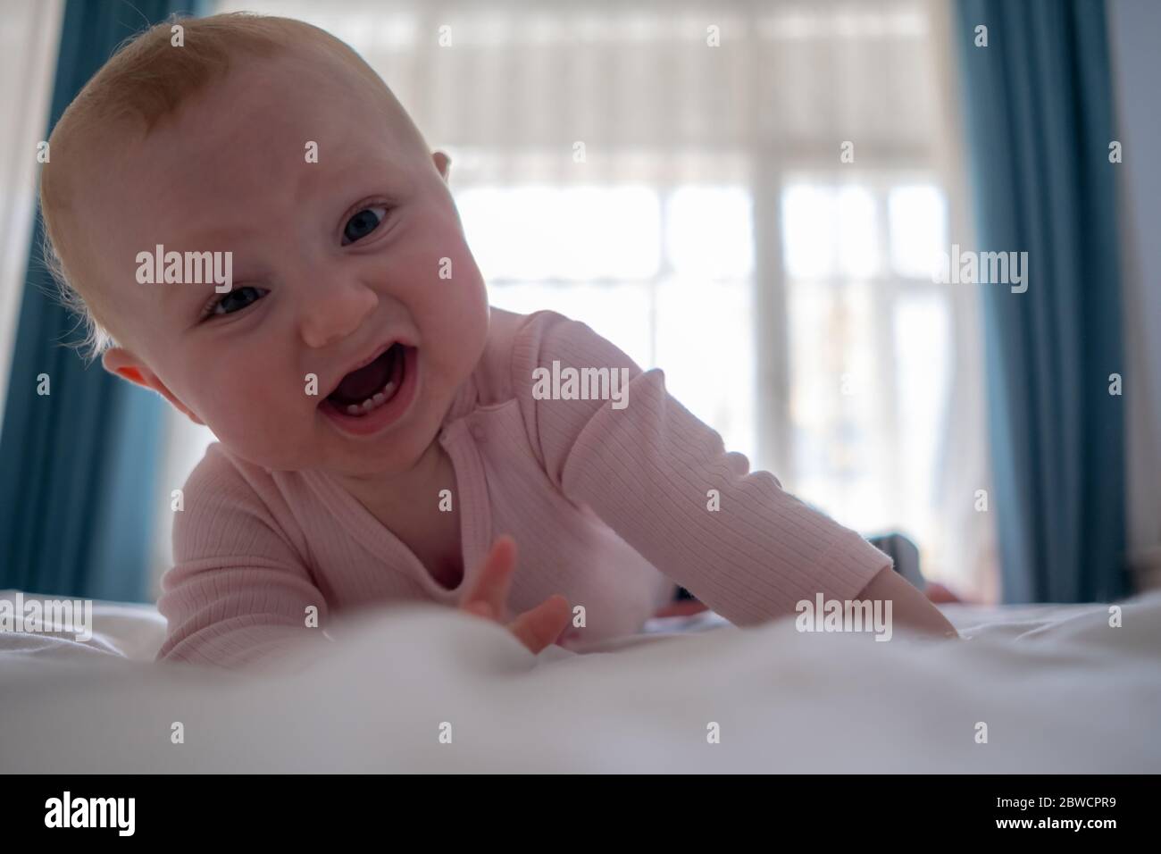 Cute Baby Girl Standing On Bed Make Funny Faces Angry Face Crying In The Morning Stock Photo Alamy