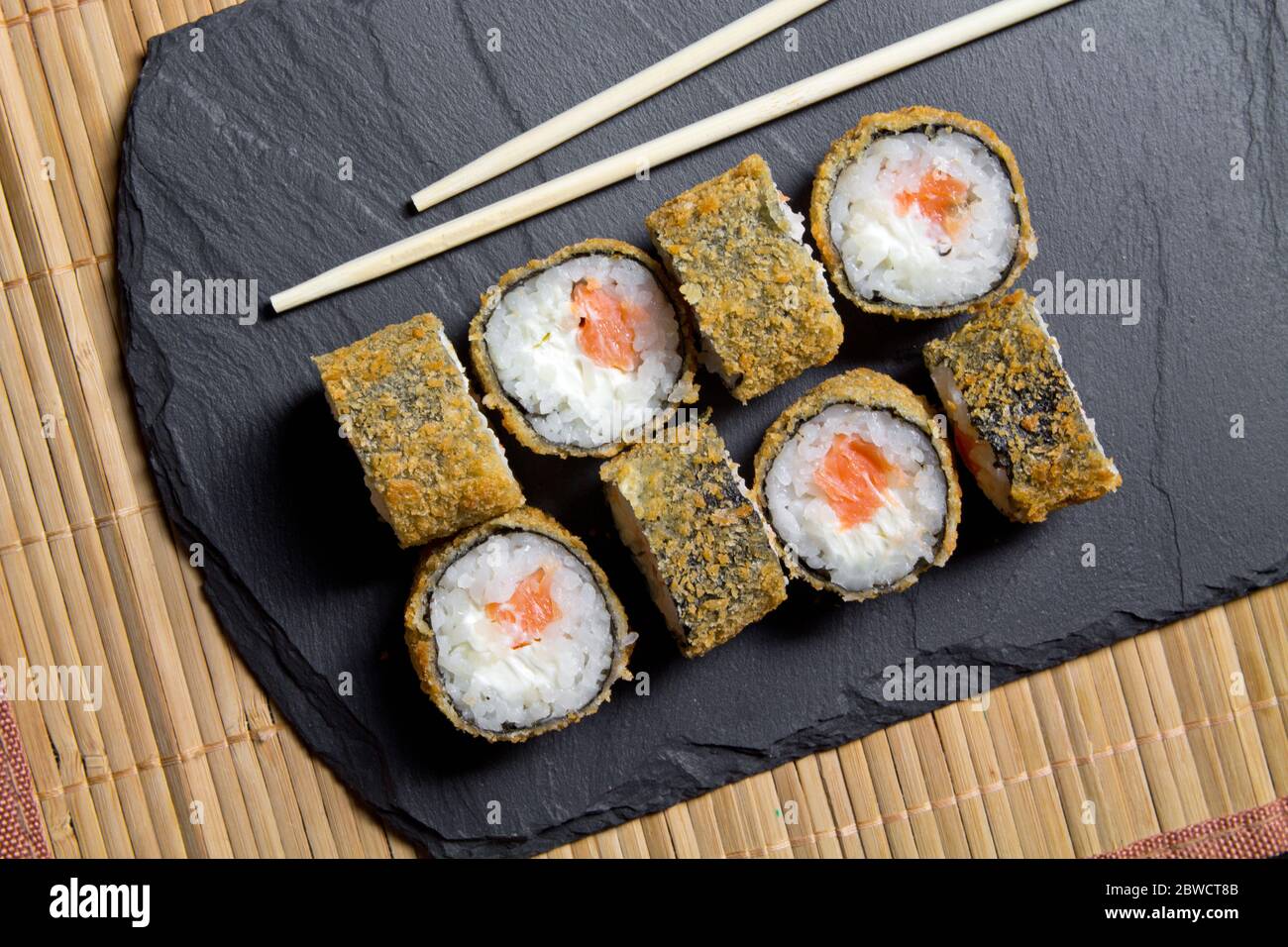 Sushi roll tempura with prawns on the mats background. Top view of