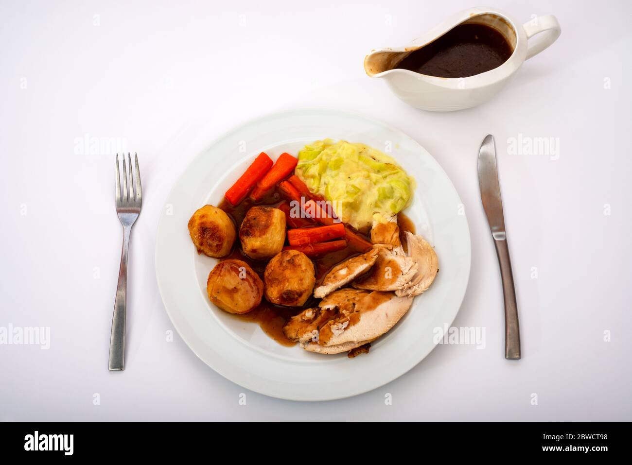 Roast chicken dinner and gravy Stock Photo Alamy