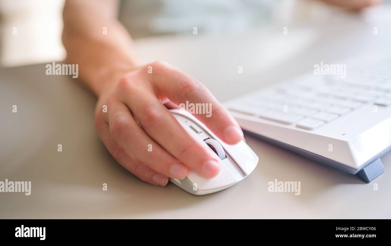the developer works at computer, uses the mouse Stock Photo