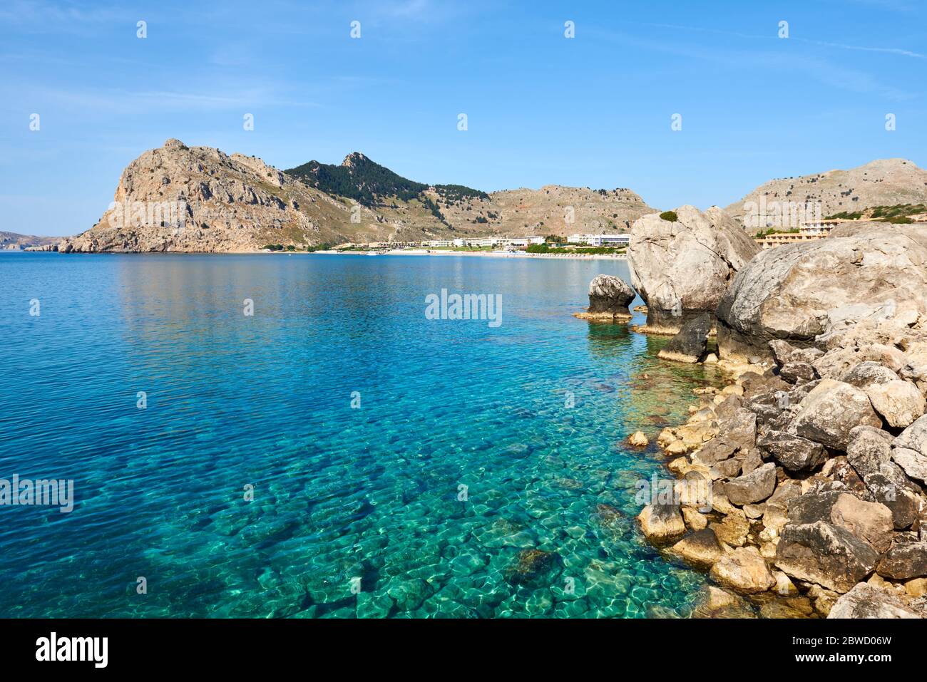 Rocky coast of Kolymbia bay in sunny day. Rhodes island, Greece Stock Photo
