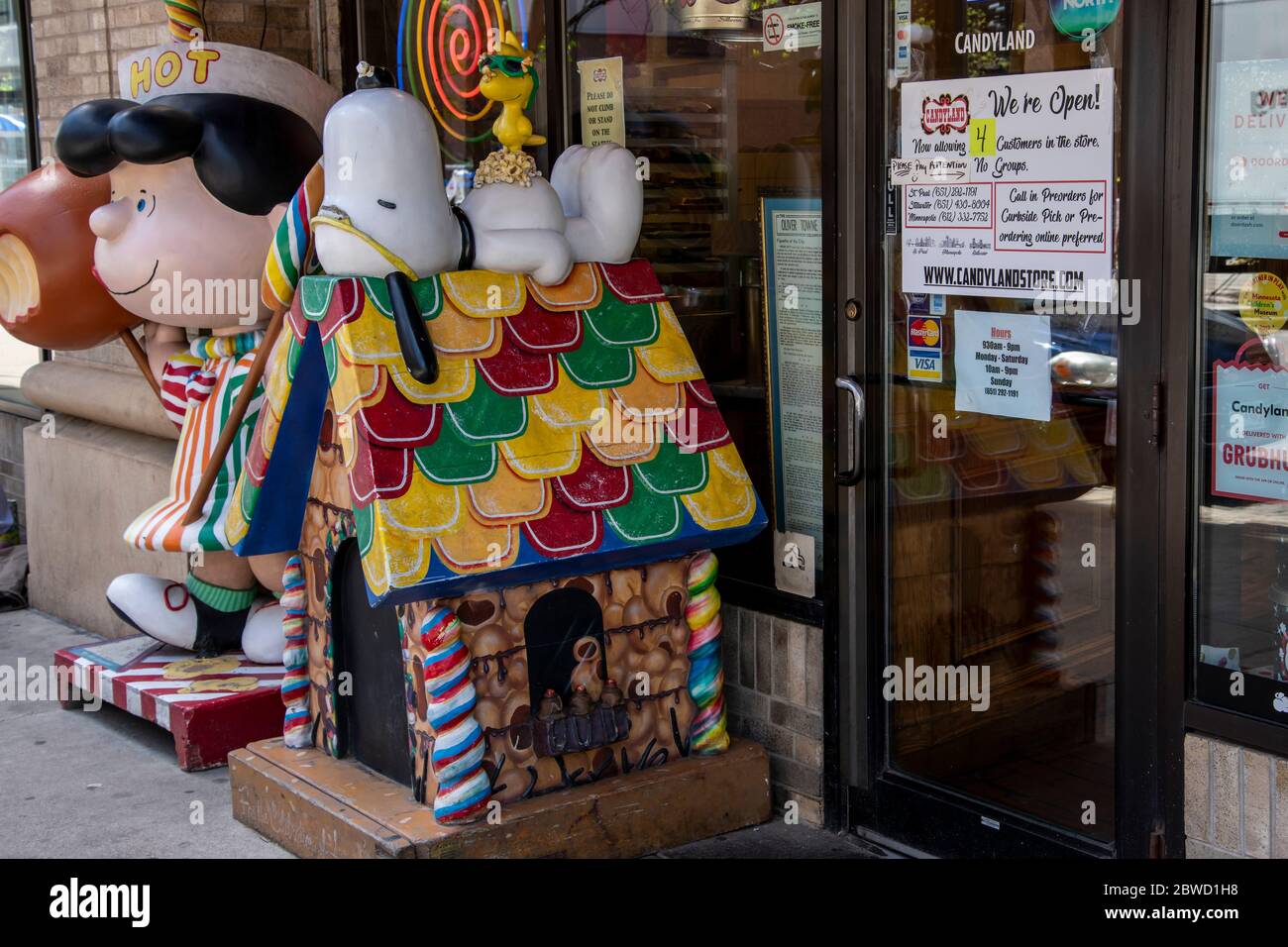 St. Paul, Minnesota. The Candyland store in downtown with a sign on the door that says only four people at a time allowed in the store and no groups. Stock Photo