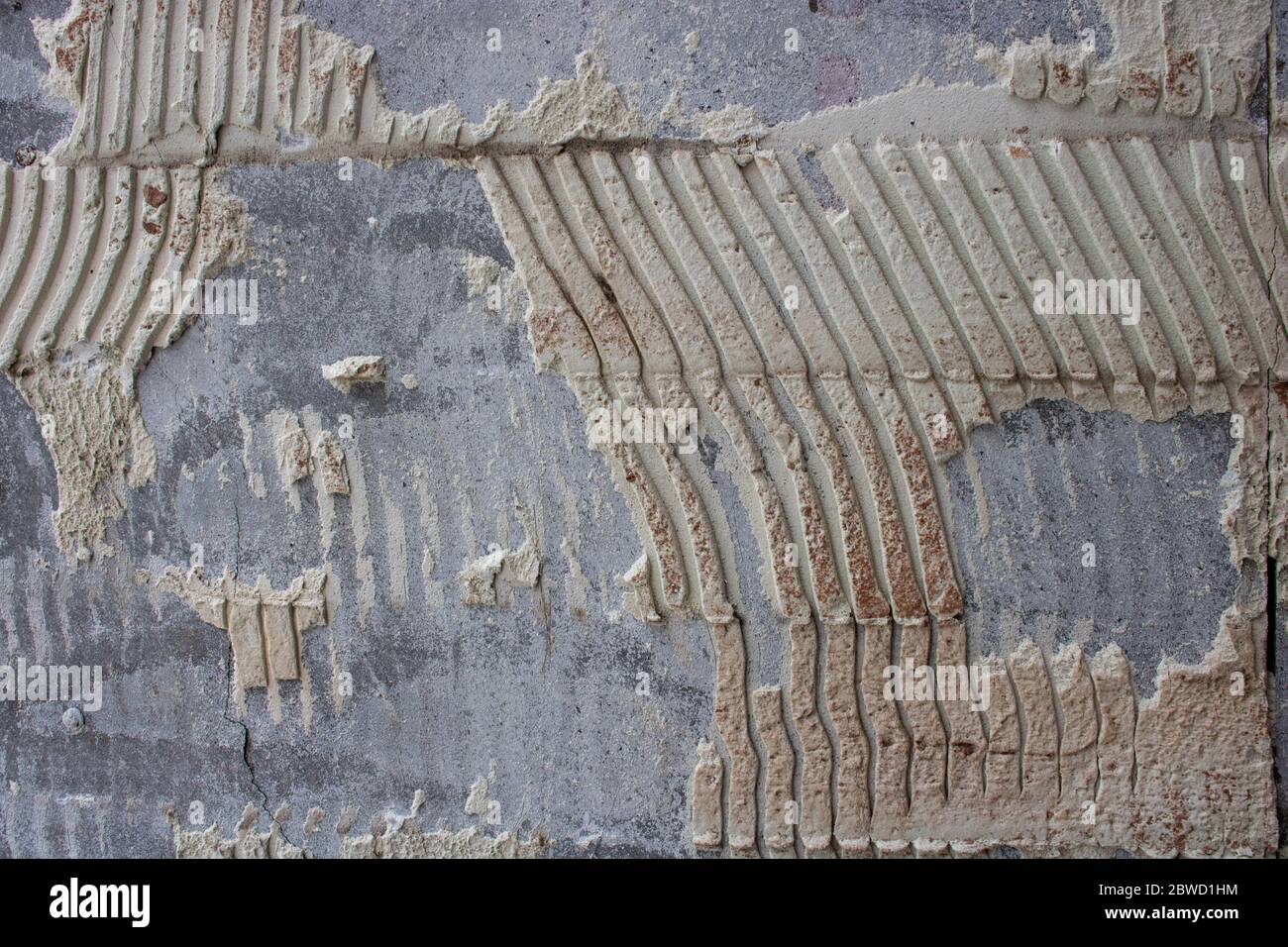 old tile glue or cement . broken wall tiles.wall without tiles Stock