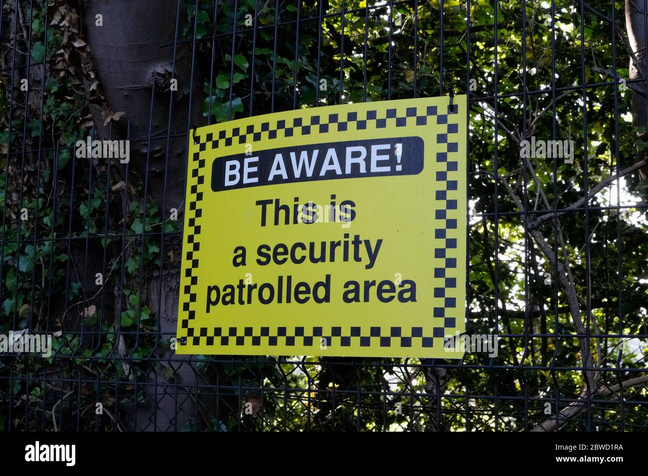 Be aware, This is a security patrolled area sign Stock Photo