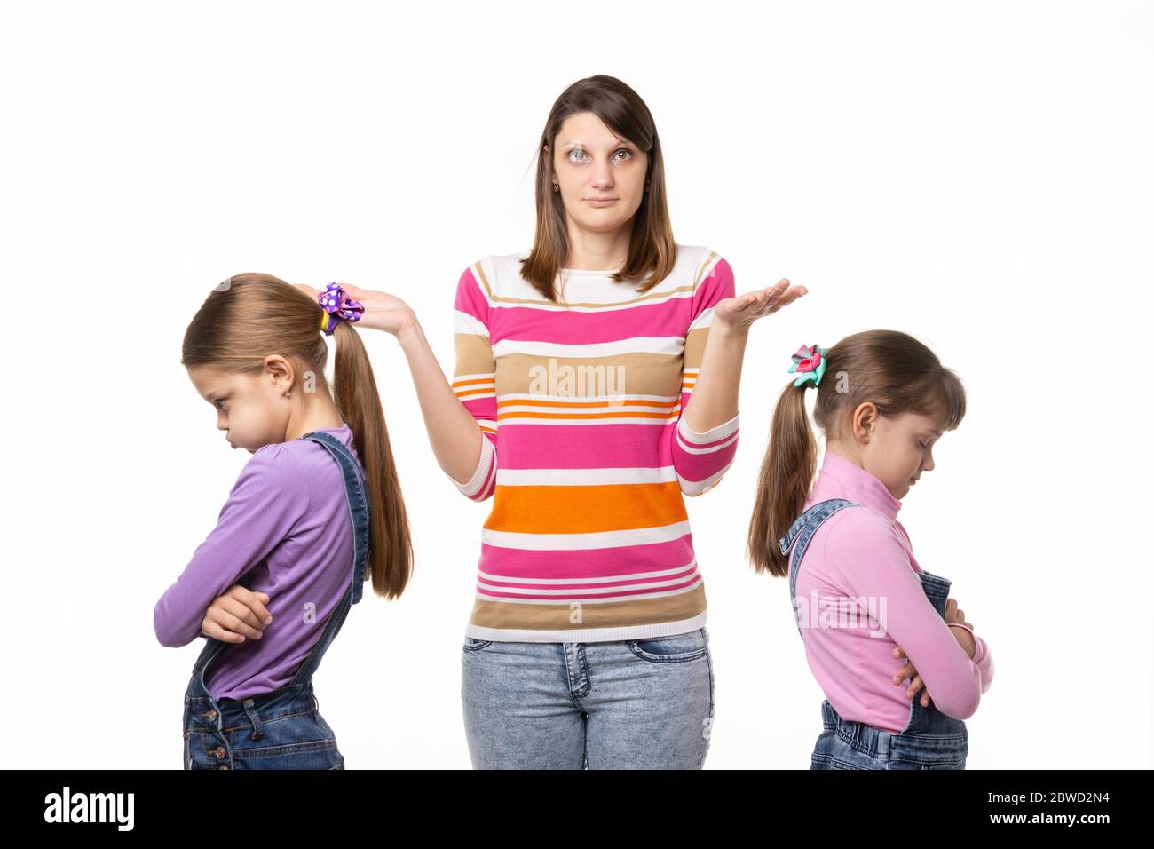Mom does not know how to reconcile offended at each other daughters Stock Photo