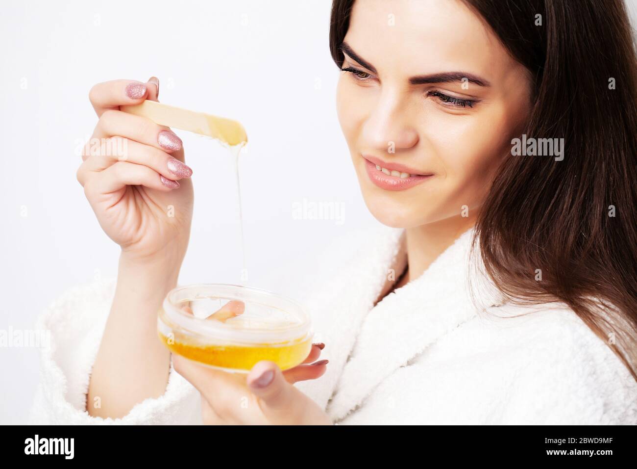 Young woman uses liquid wax to remove hair Stock Photo Alamy