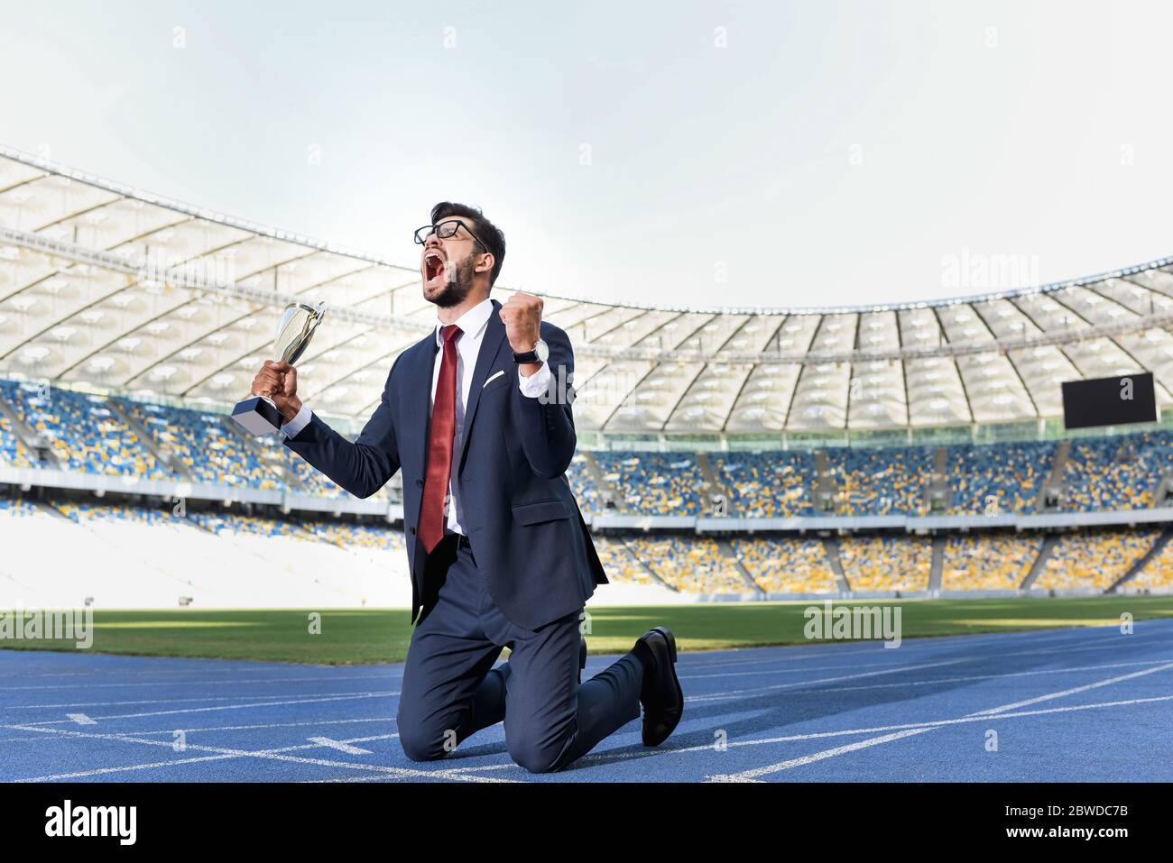 Man on suit on knees hi-res stock photography and images - Alamy