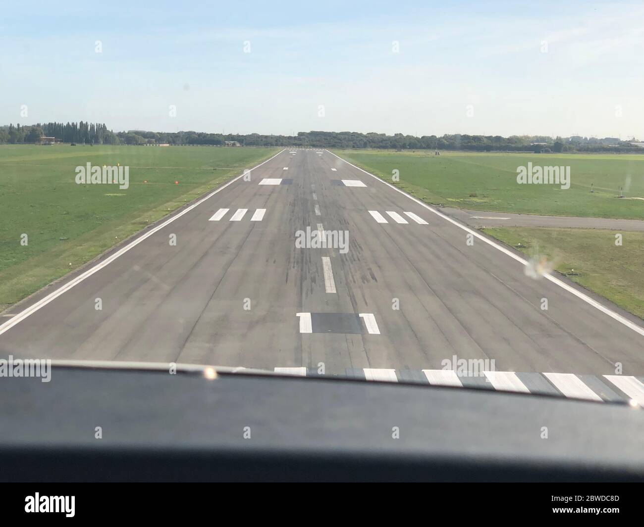 Approaching a runway strip with a propeller plane Stock Photo