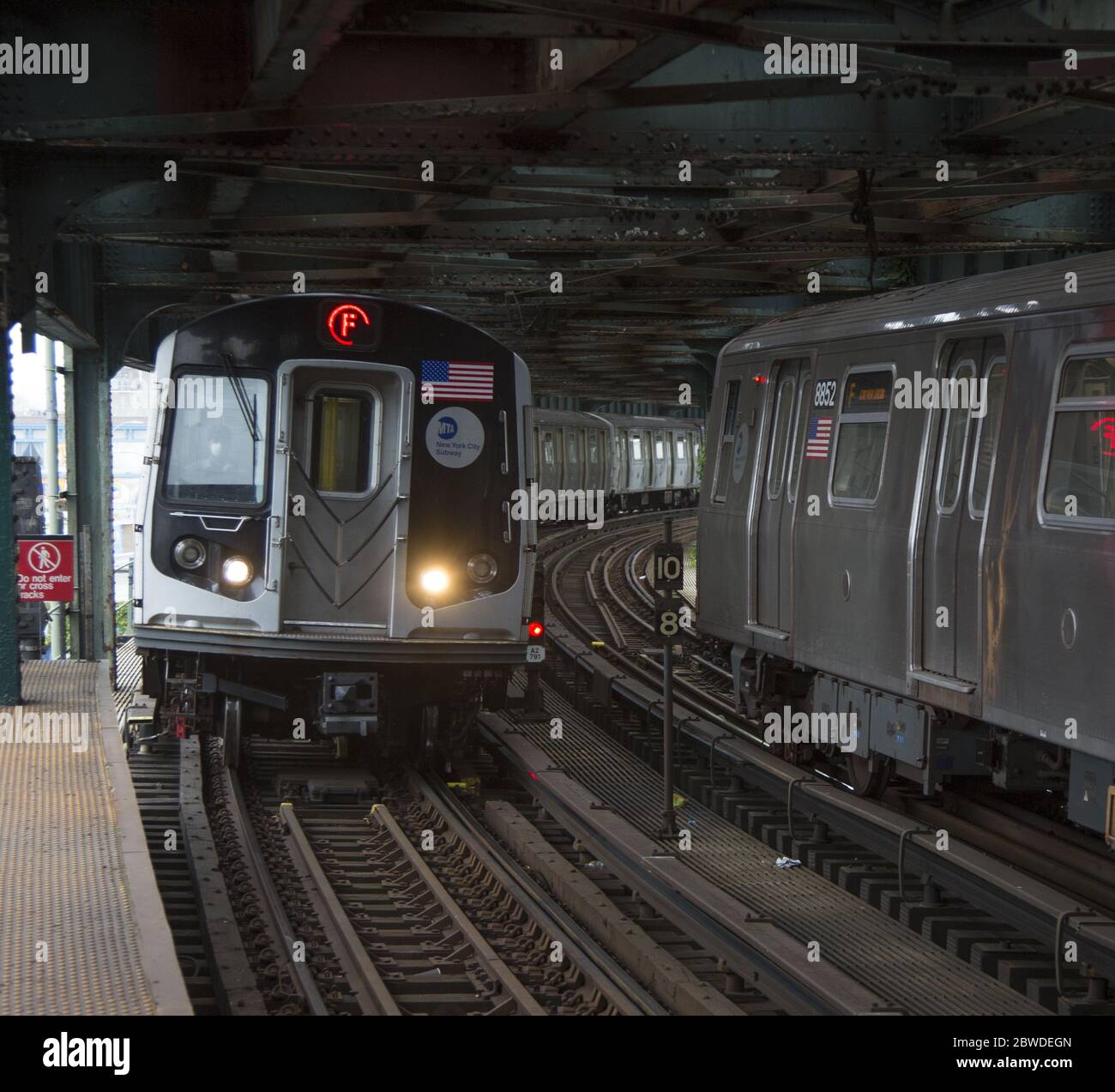Subway trains enter and exit the West 8th Street elevated subway station at Coney Island, Brooklyn, New York. Stock Photo