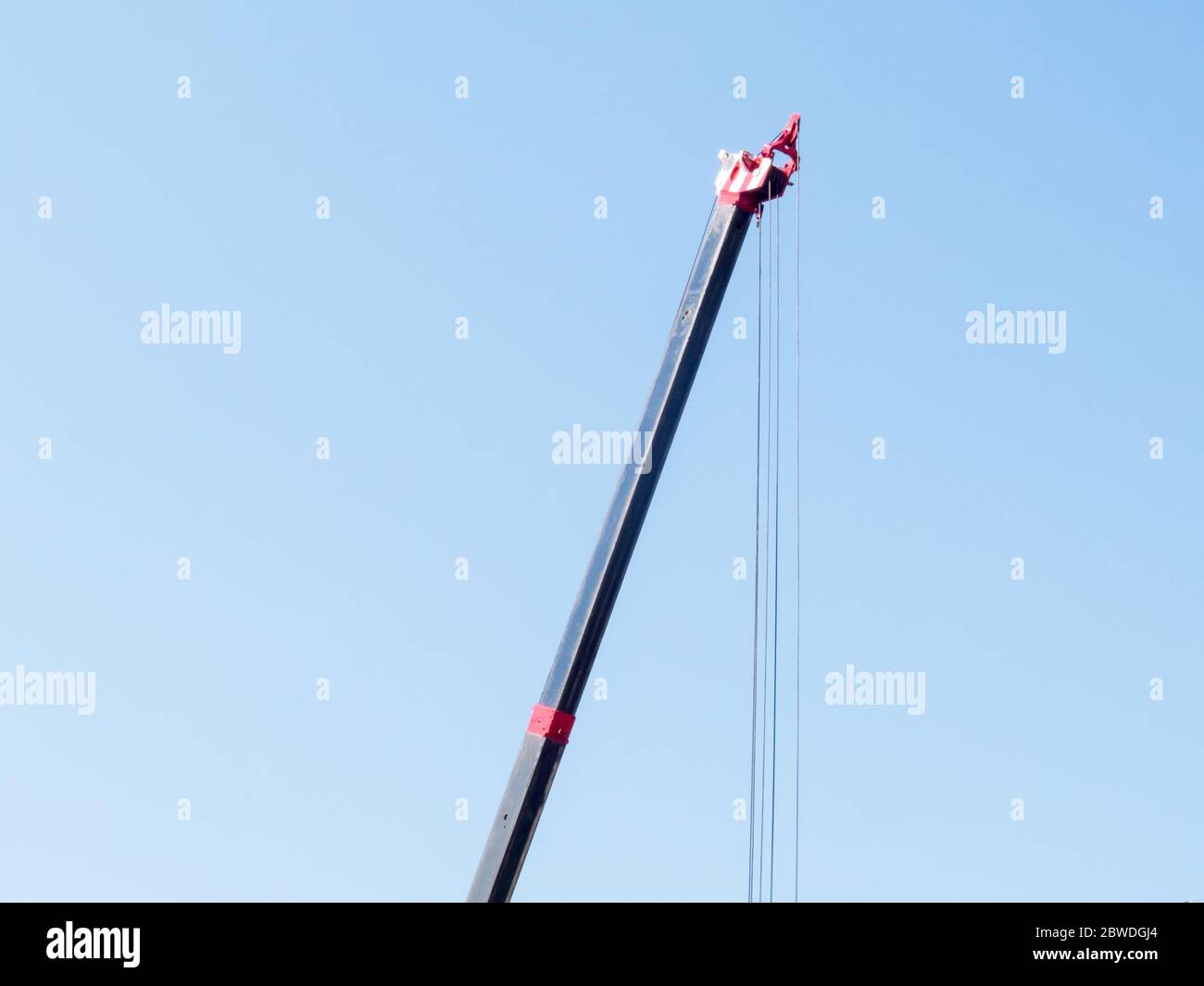 Crane on a blue sky background Stock Photo - Alamy