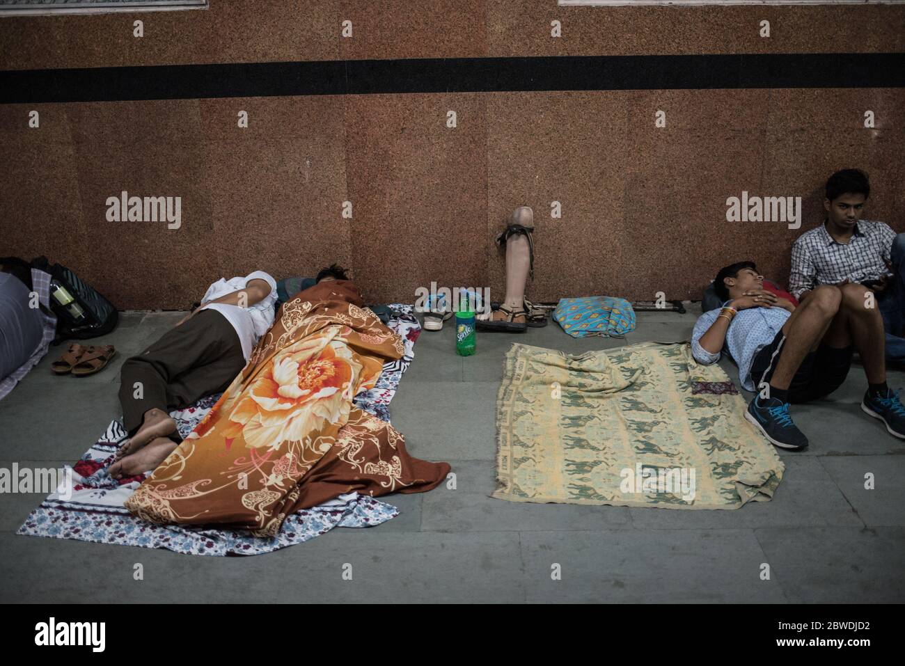 Passengers sleeping on floor of train station, India. Indian Railways. Rail Travel. Migrants. Stock Photo
