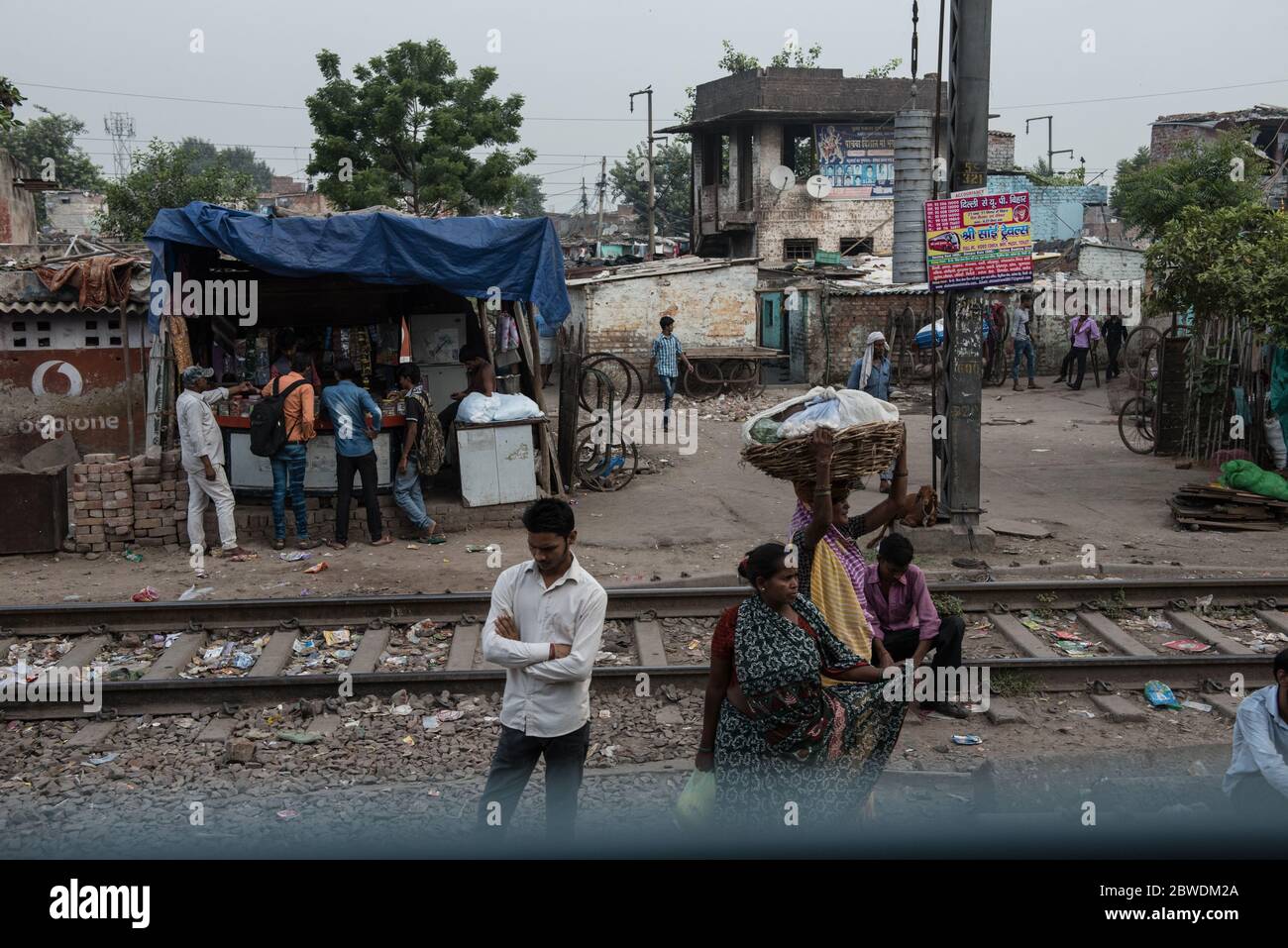 Crowded slums alongside the train tracks. New Delhi, India. India Railways. Stock Photo