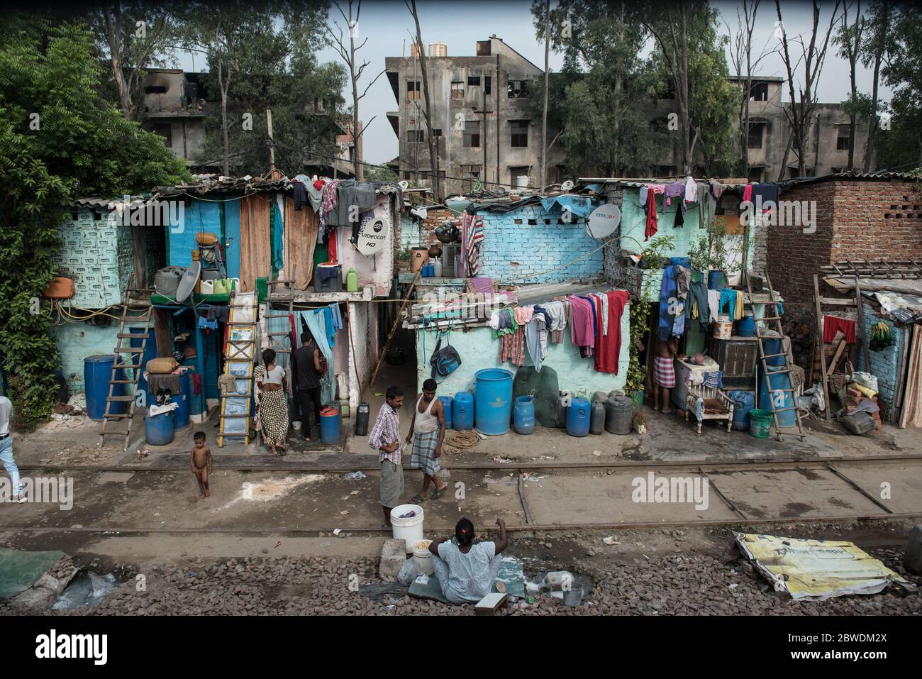 Crowded slums alongside the train tracks. New Delhi, India. India ...