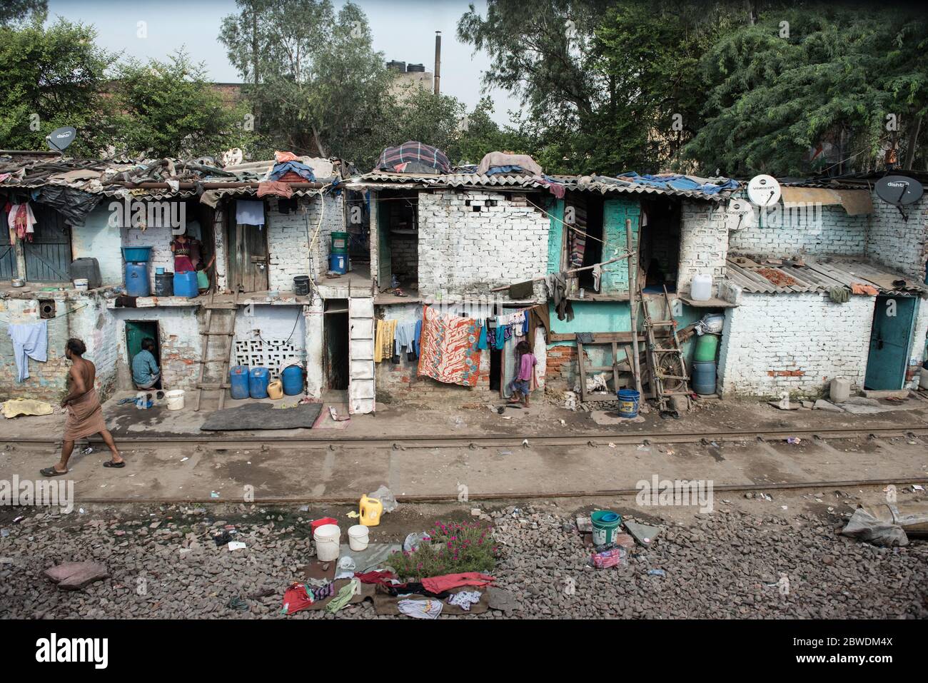Crowded slums alongside the train tracks. New Delhi, India. India ...