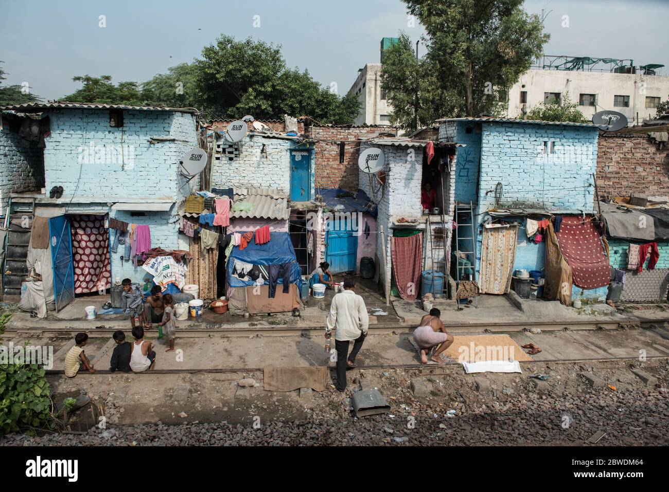 Crowded slums alongside the train tracks. New Delhi, India. India Railways. Stock Photo