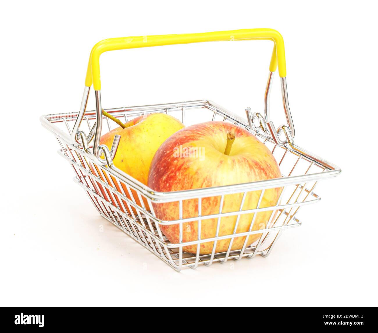 a small shopping basket with fruits, apples, on a white background. Healthy food, vegetarian food, vegetables, shopping at the supermarket. Stock Photo