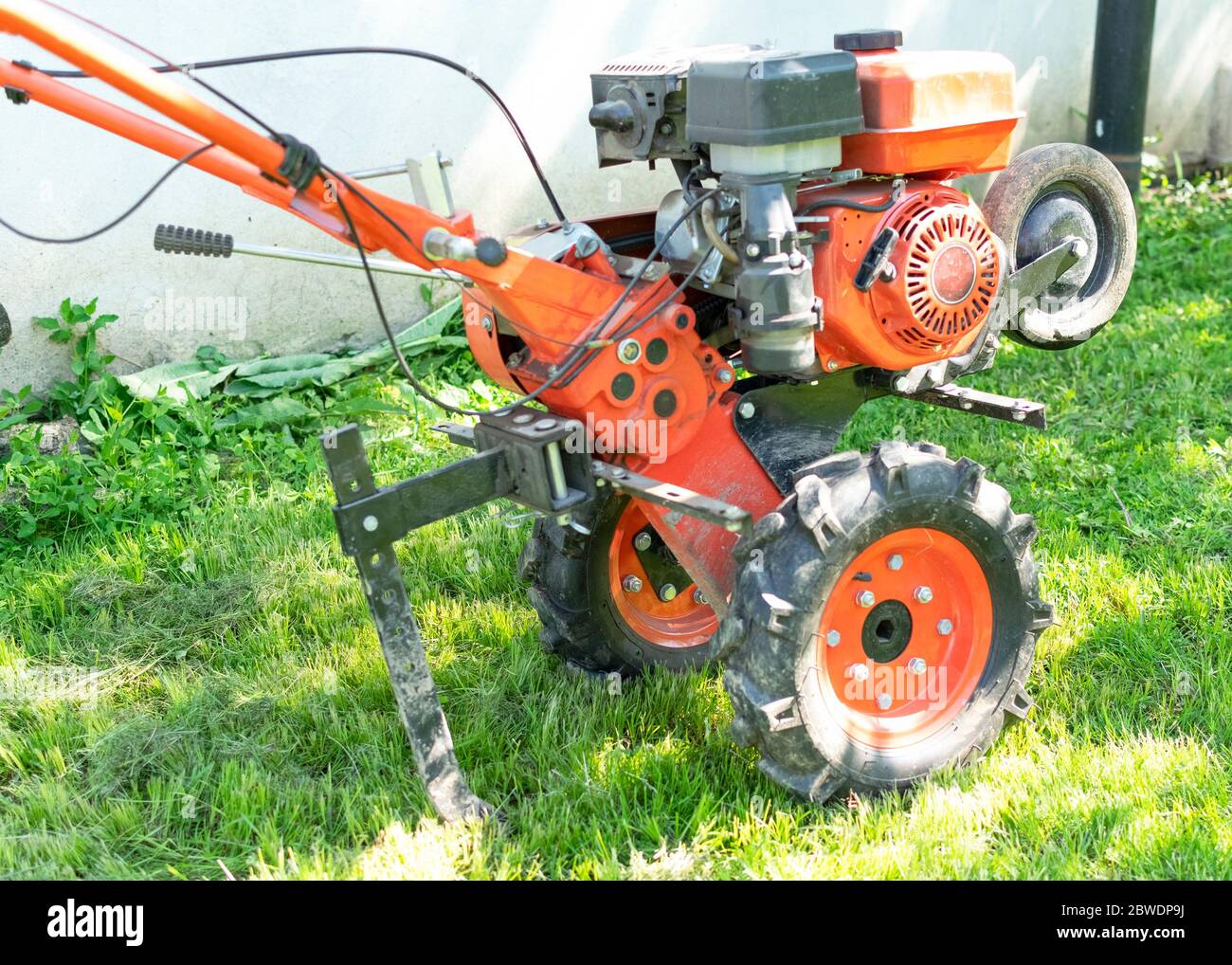 Man Farmer plows the land with a cultivator. Agricultural machinery