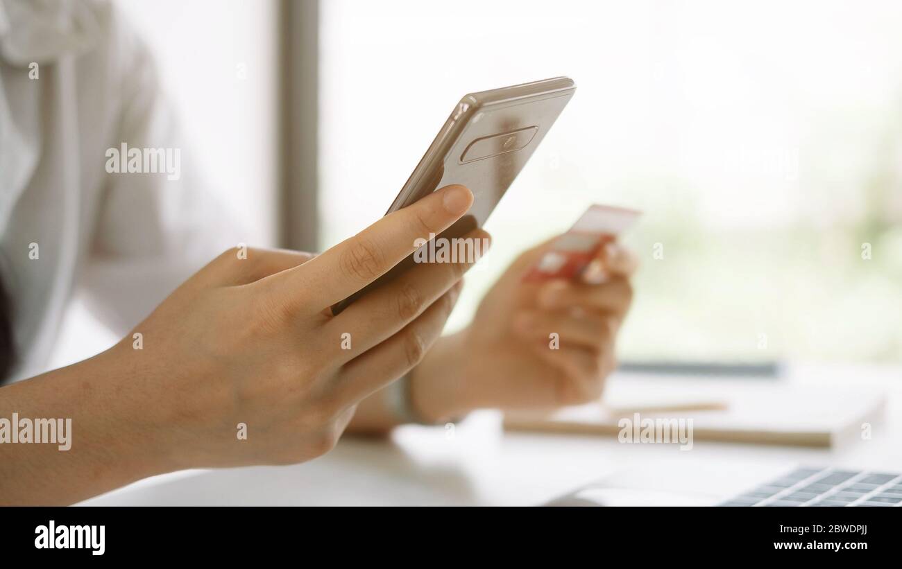 Shopping online with smartphone and credit card on hand Stock Photo