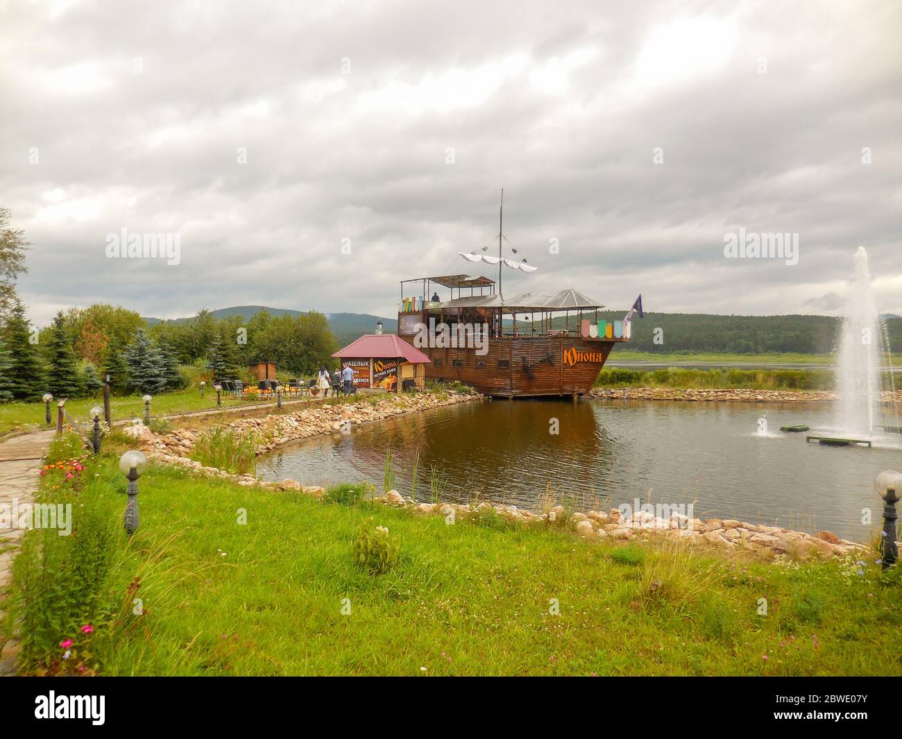 chelyabinsk, russia 06 06 2019: Restaurant on the wooden ship next to the waterfall. Recreational place. Stock Photo