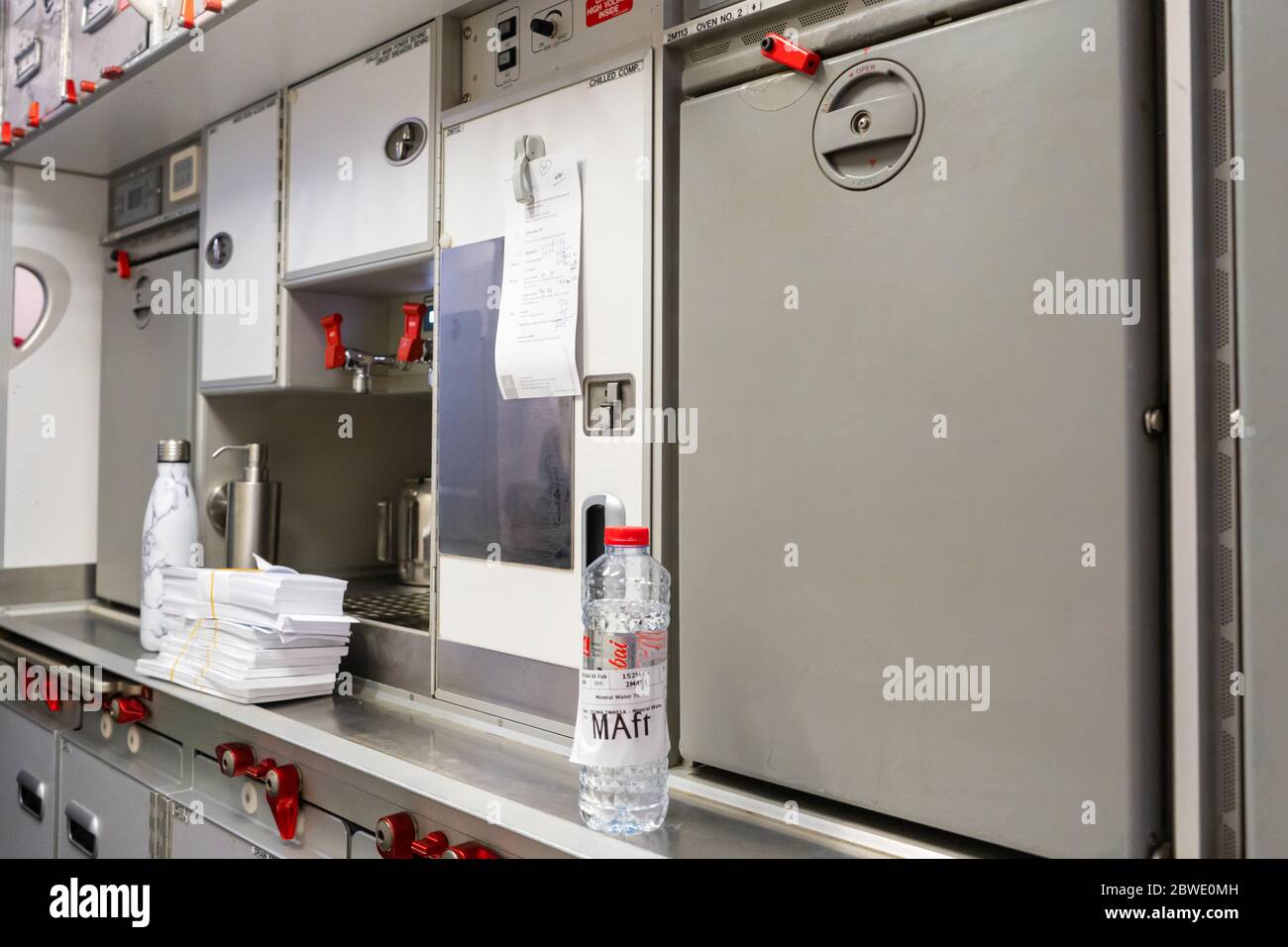 https://c8.alamy.com/comp/2BWE0MH/kitchen-on-the-plane-food-storage-shelves-and-water-dispenser-2BWE0MH.jpg