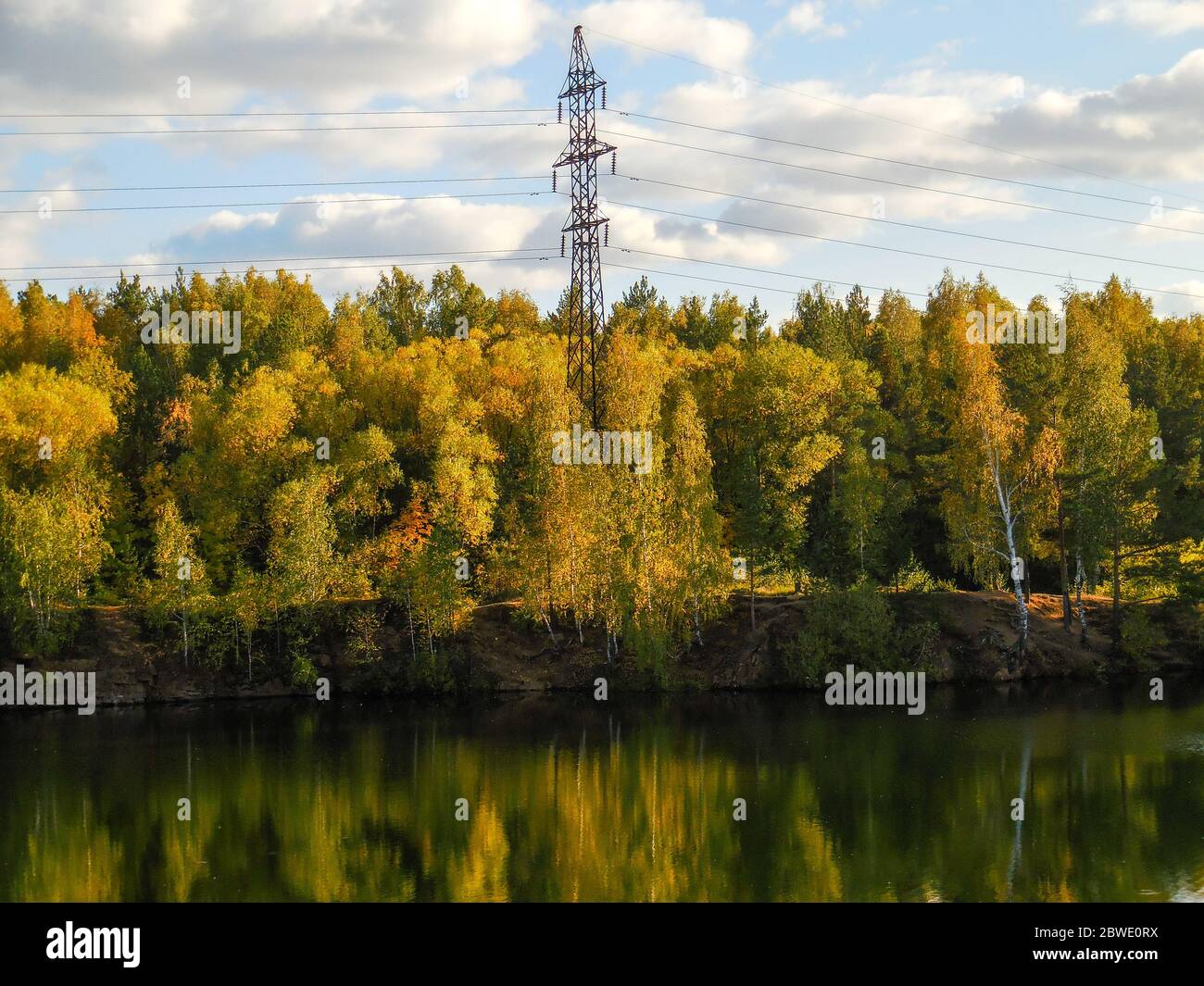 chelyabinsk, russia 06 06 2019: Forest by the lake in russia. Falling shade of trees in lake water. Stock Photo