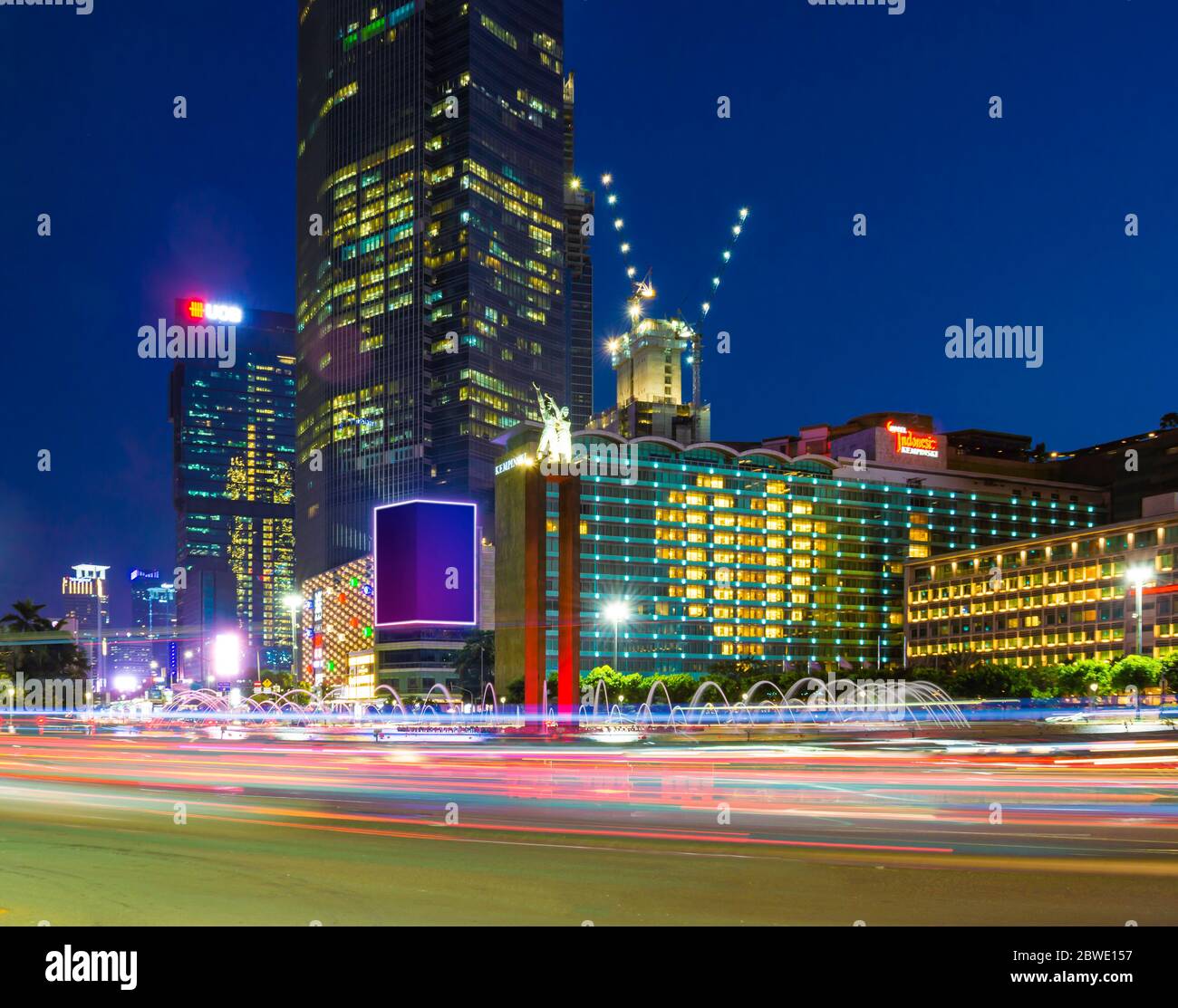 The street around HI Roundabout in Central Jakarta, Indonesia. The lamps in the hotel have been arranged in heart shape for covid victims. Stock Photo