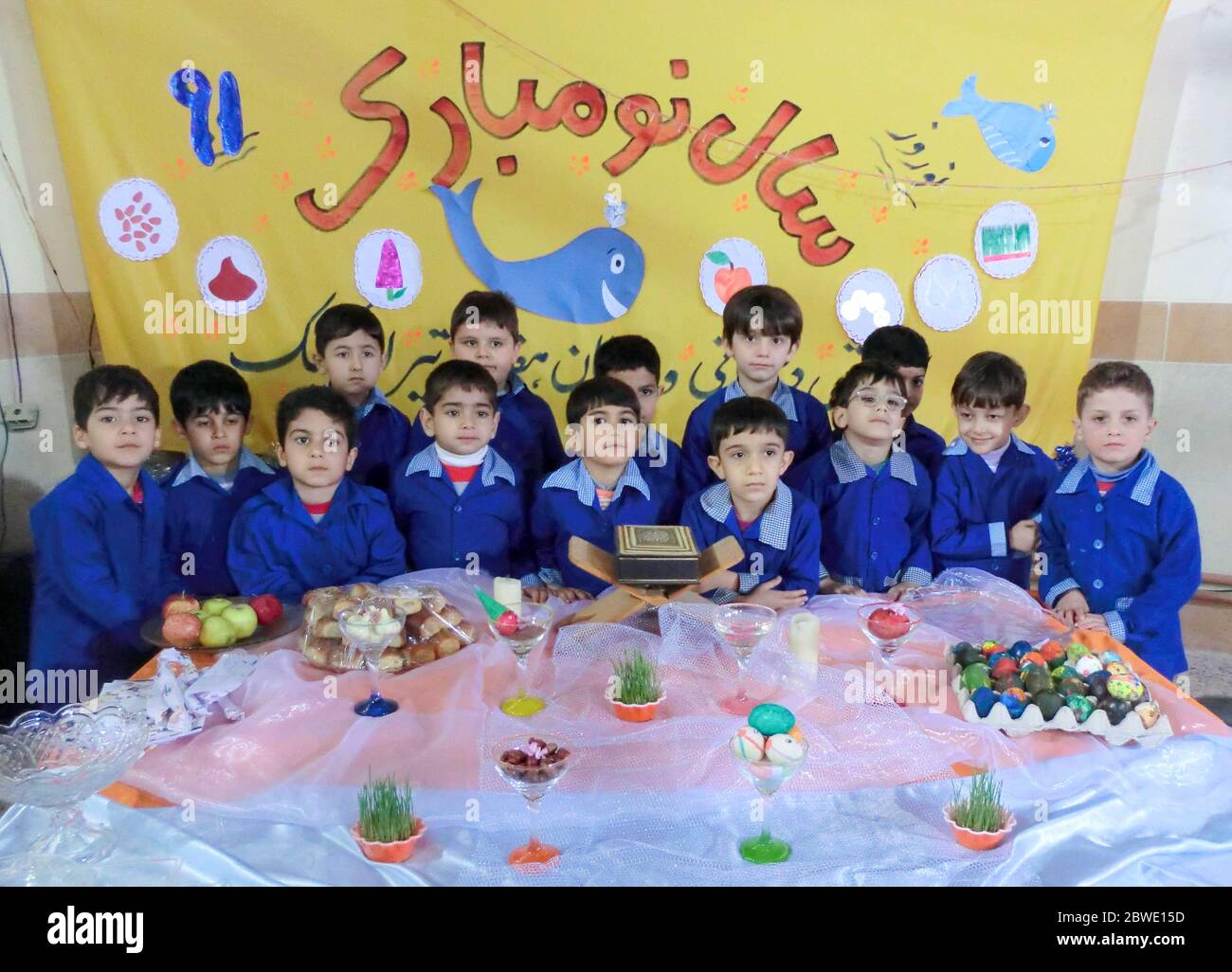 Rasht, Gilan, Iran, 05 05 2019. New Year's Eve Celebration at Boys' School in Iran. School students by Nowruz table. Students in school uniform at New Stock Photo