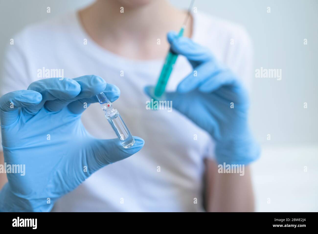 Close up of hands with syringe and vial of medication. Injecting injection, Vaccine vaccination flu, Doctor. Mockup. Copy space. Stock Photo