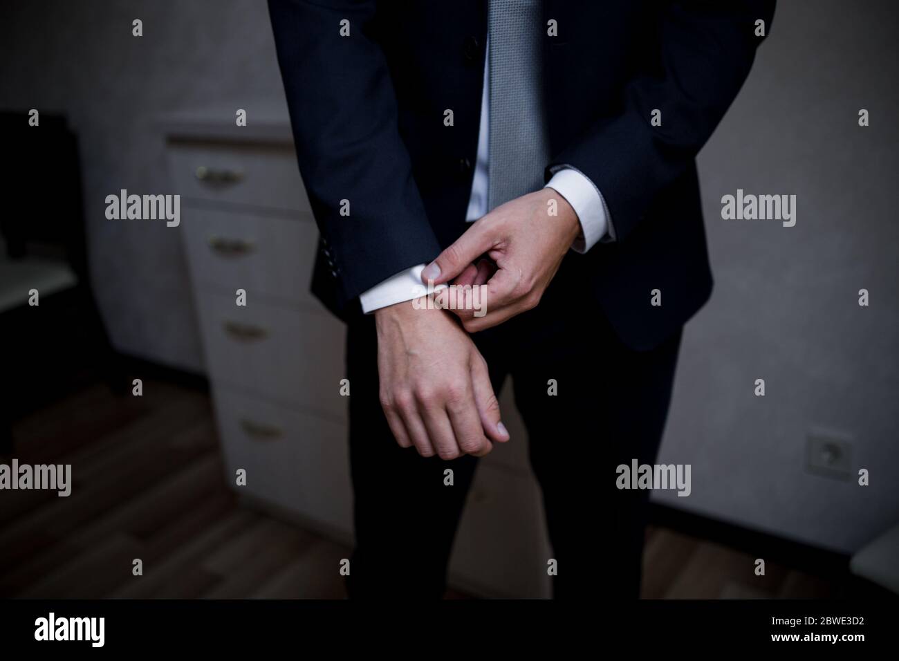 Man puts on suit jacket hi-res stock photography and images - Alamy