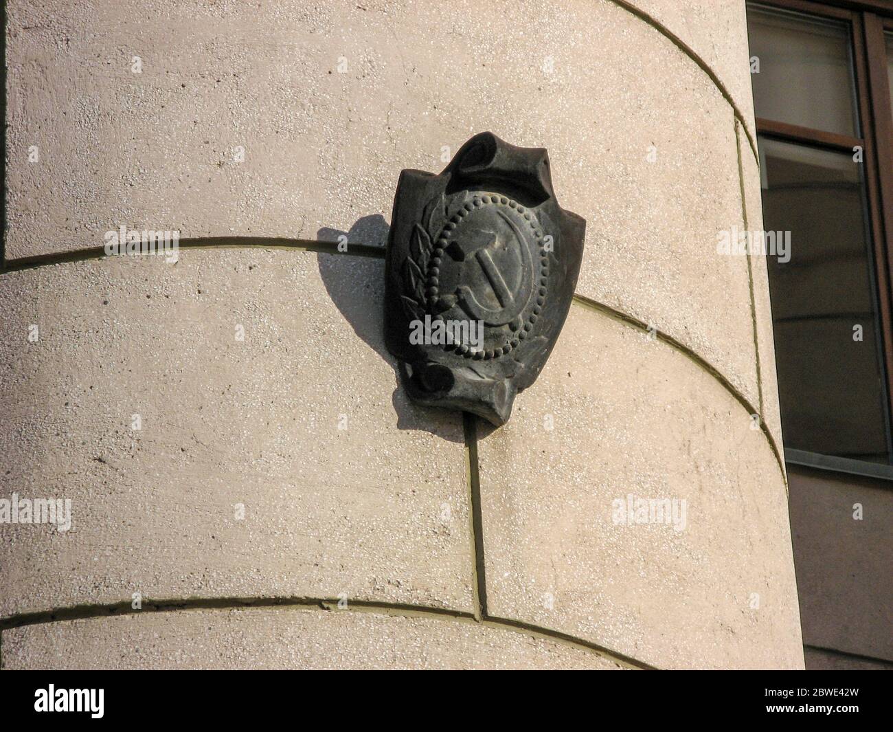 Symbol of the USSR in outside the building in chelyabinsk, russia.  The hammer and sickle on the wall of the building in chelyabinsk. Communist symbol Stock Photo