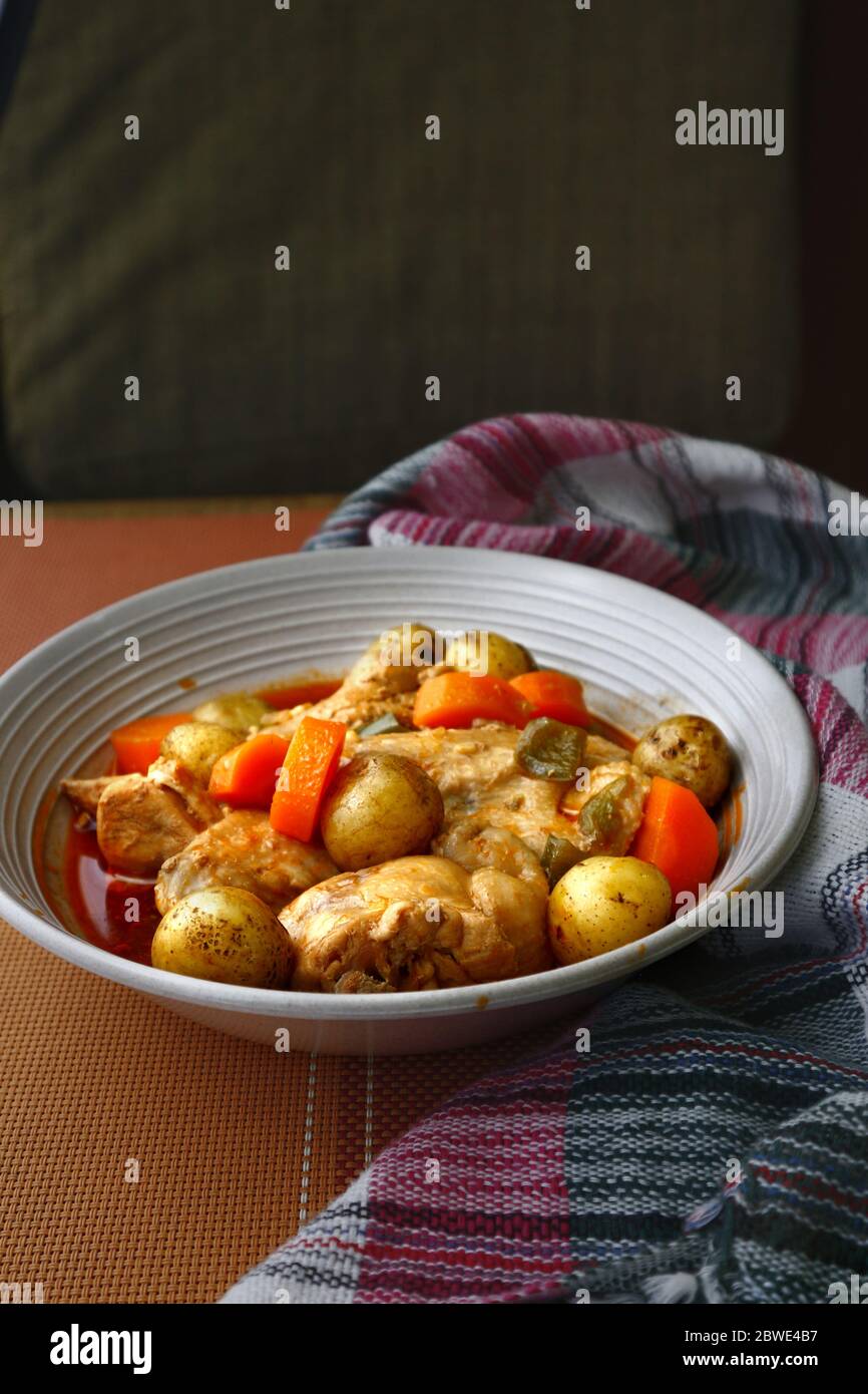 Photo of freshly cooked Filipino food Chicken Afritada or chicken cooked in tomato sauce with potatoes and carrots. Stock Photo