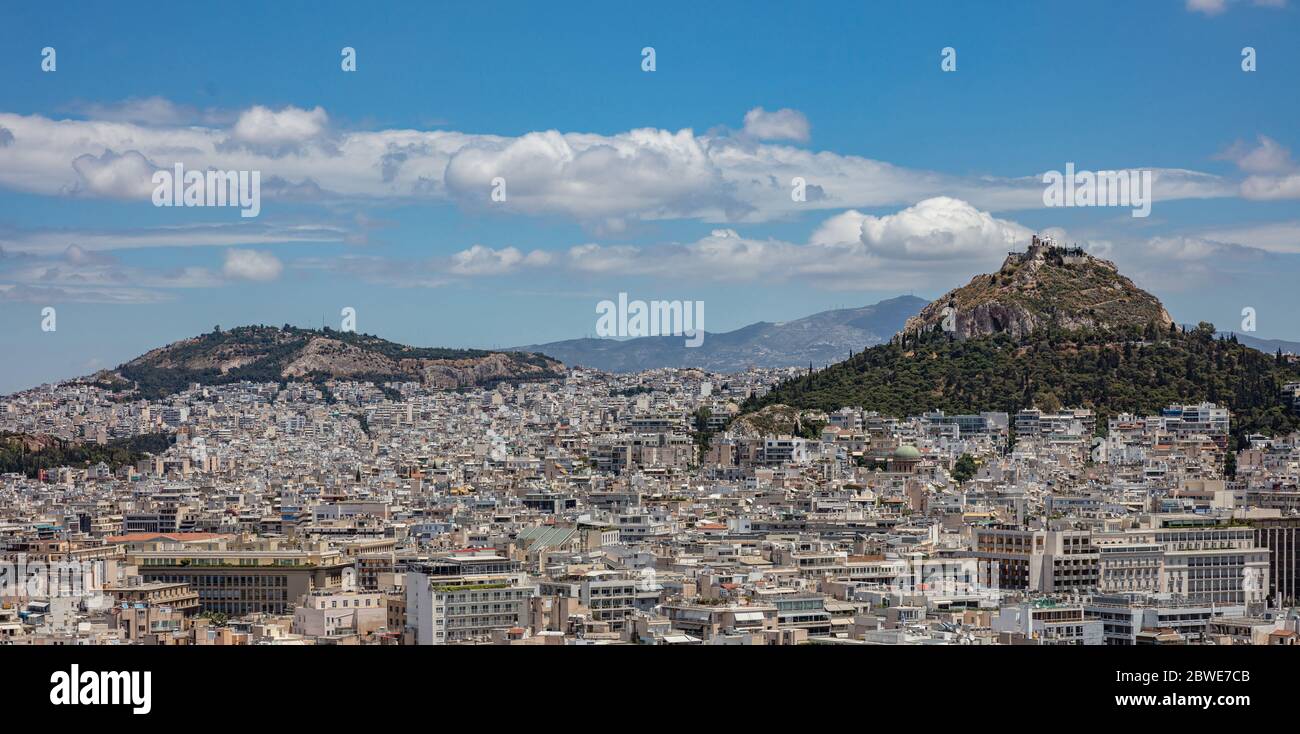 Mount Lycabettus and Athens cityscape aerial photo,  view from Acropolis hill in Greece. Blue sky with clouds, sunny spring day. Stock Photo