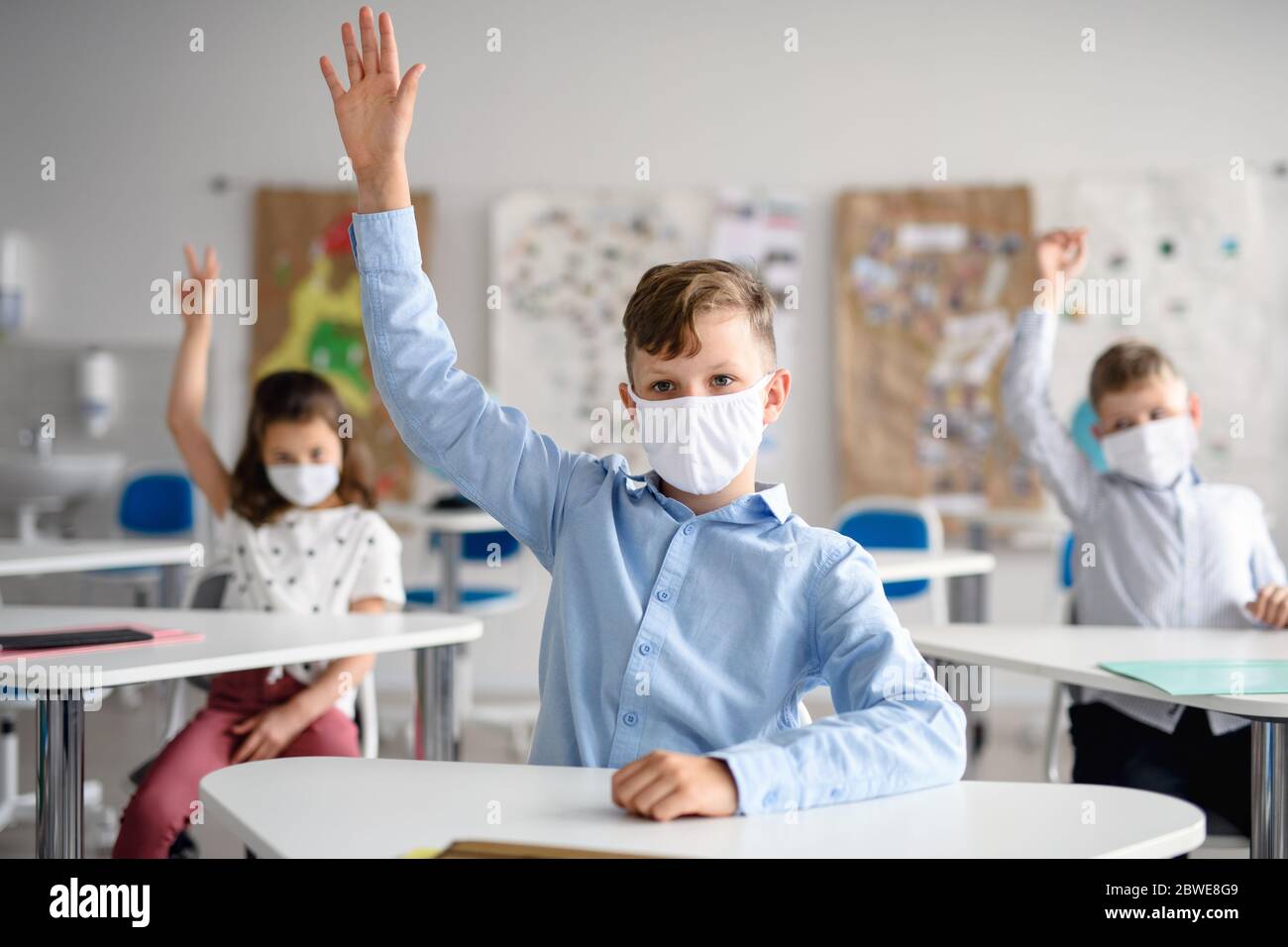 Boy with face mask back at school after covid-19 quarantine and ...