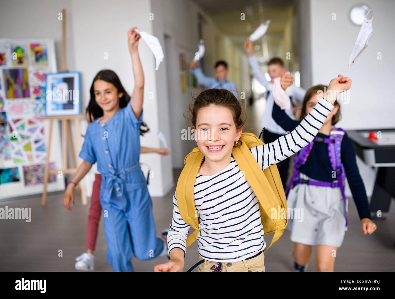 Group of cheerful children going home from school after covid-19 quarantine and lockdown. Stock Photo