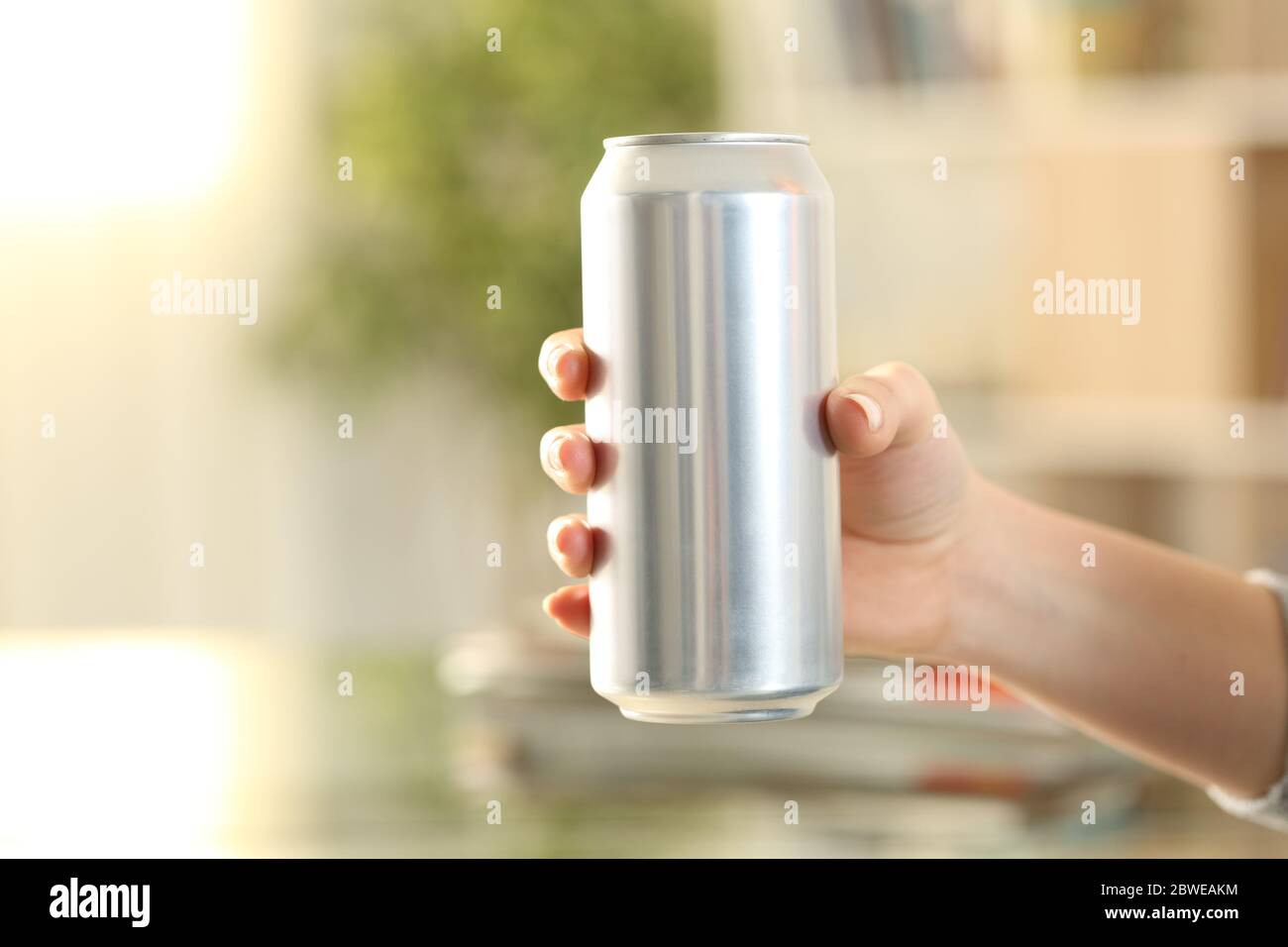 Close up of woman hand holding a soda drink can at home Stock Photo