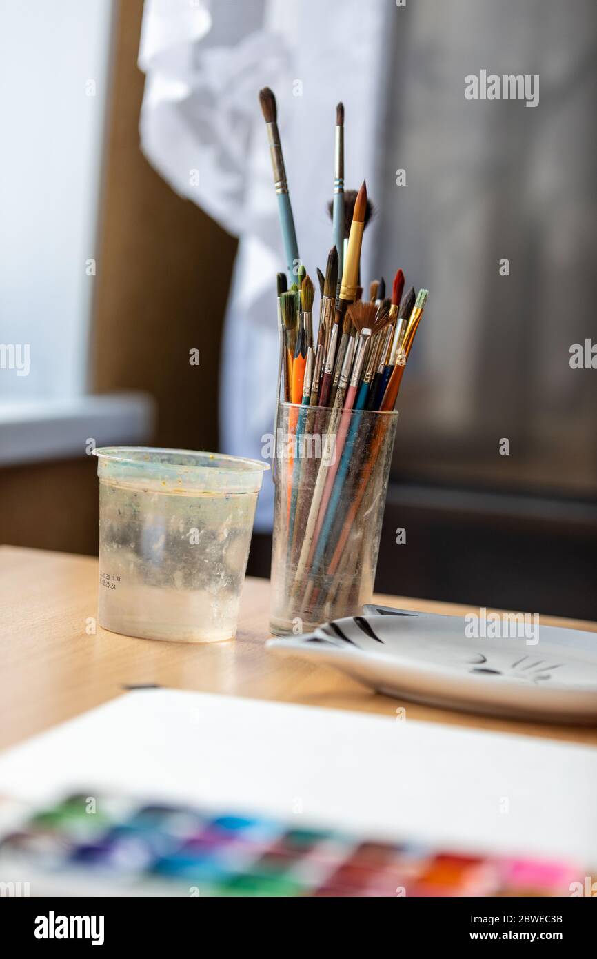 Art brushes for painting in a glass cup on the desktop Stock Photo Alamy