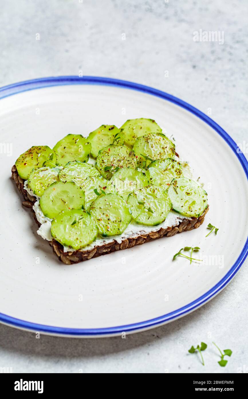 Cucumber and cream cheese toast on a plate. Healthy vegetarian diet concept Stock Photo Alamy