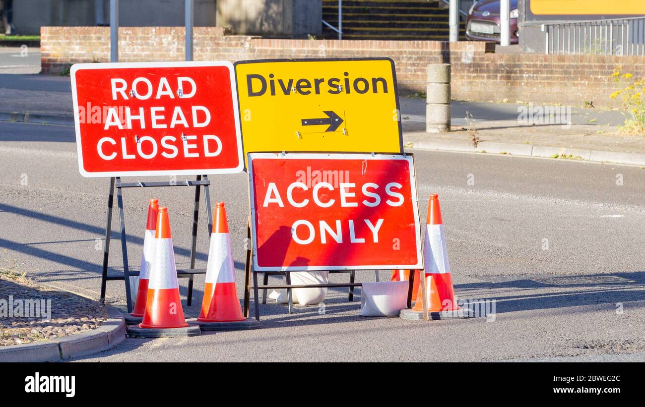Red and Yellow Road Signs Indicating a Road Closure and Diversion Stock Photo