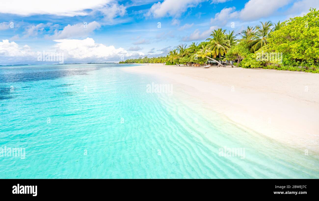 Beautiful relax beach tropical blue sea. Wonderful beach nature. Luxury resort background for summer vacation and holiday. Exotic beach, vibes, mood Stock Photo