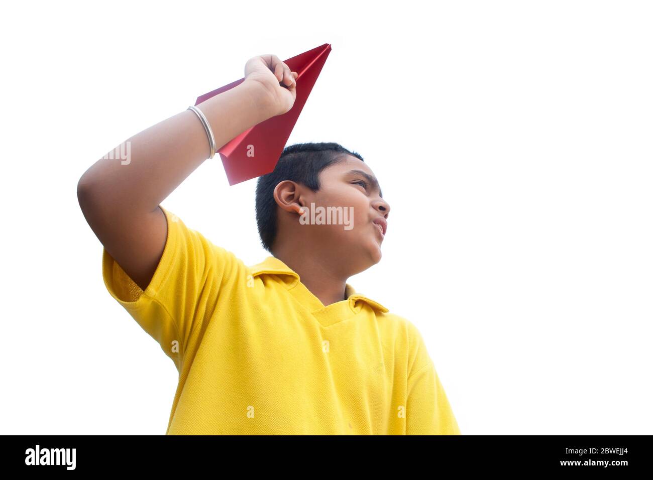 Boy playing with a paper plane and smiling Stock Photo