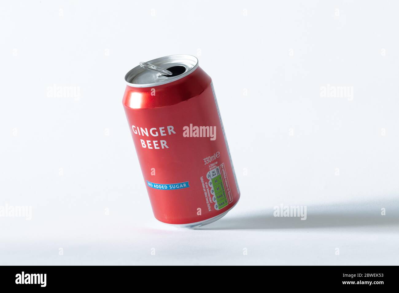 An opened can of ginger beer on a white isolated background. Drink and recycling concept. Stock Photo