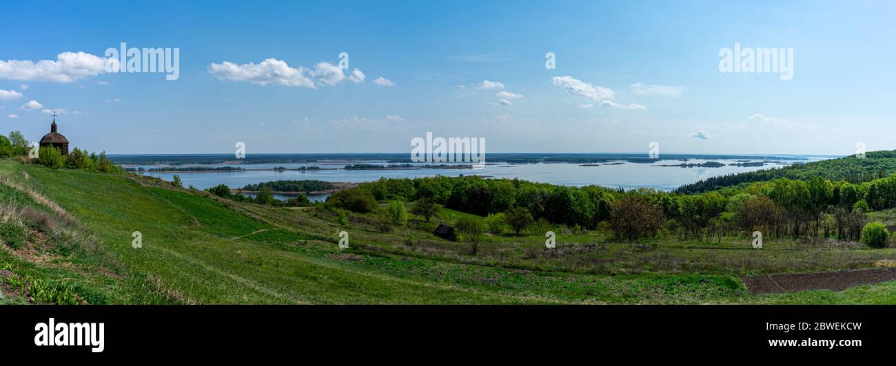 Panorama of Dnieper with old wood church in Vytachiv, Ukraine on May 3, 2020. Stock Photo