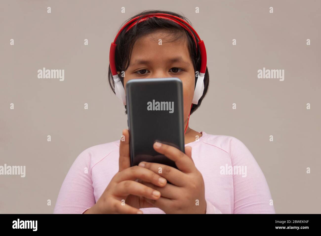 Girl Listening Music While Using Smart Phone Stock Photo