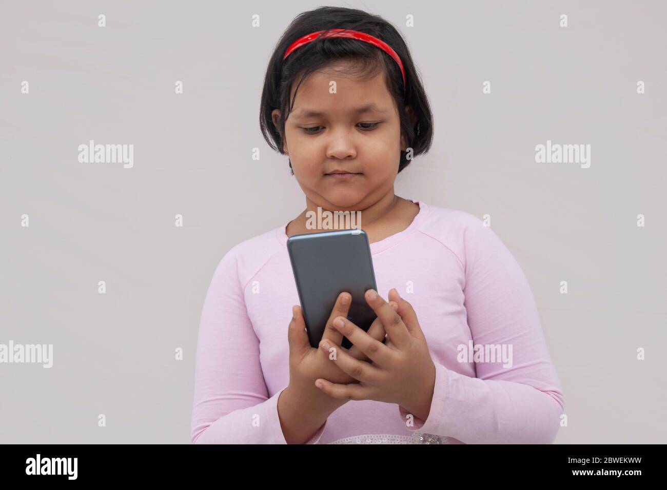 Happy child using a smart phone Stock Photo