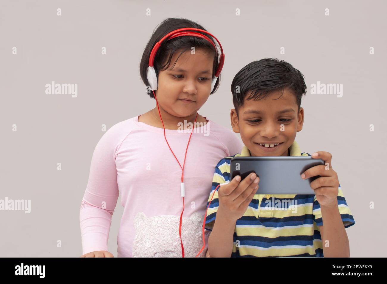 Happy Kids using a smart phone Stock Photo